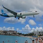 An airtransit plane landing at maho beach in st maarten