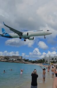 An airtransit plane landing at maho beach in st maarten
