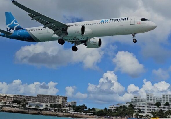 An airtransit plane landing at maho beach in st maarten